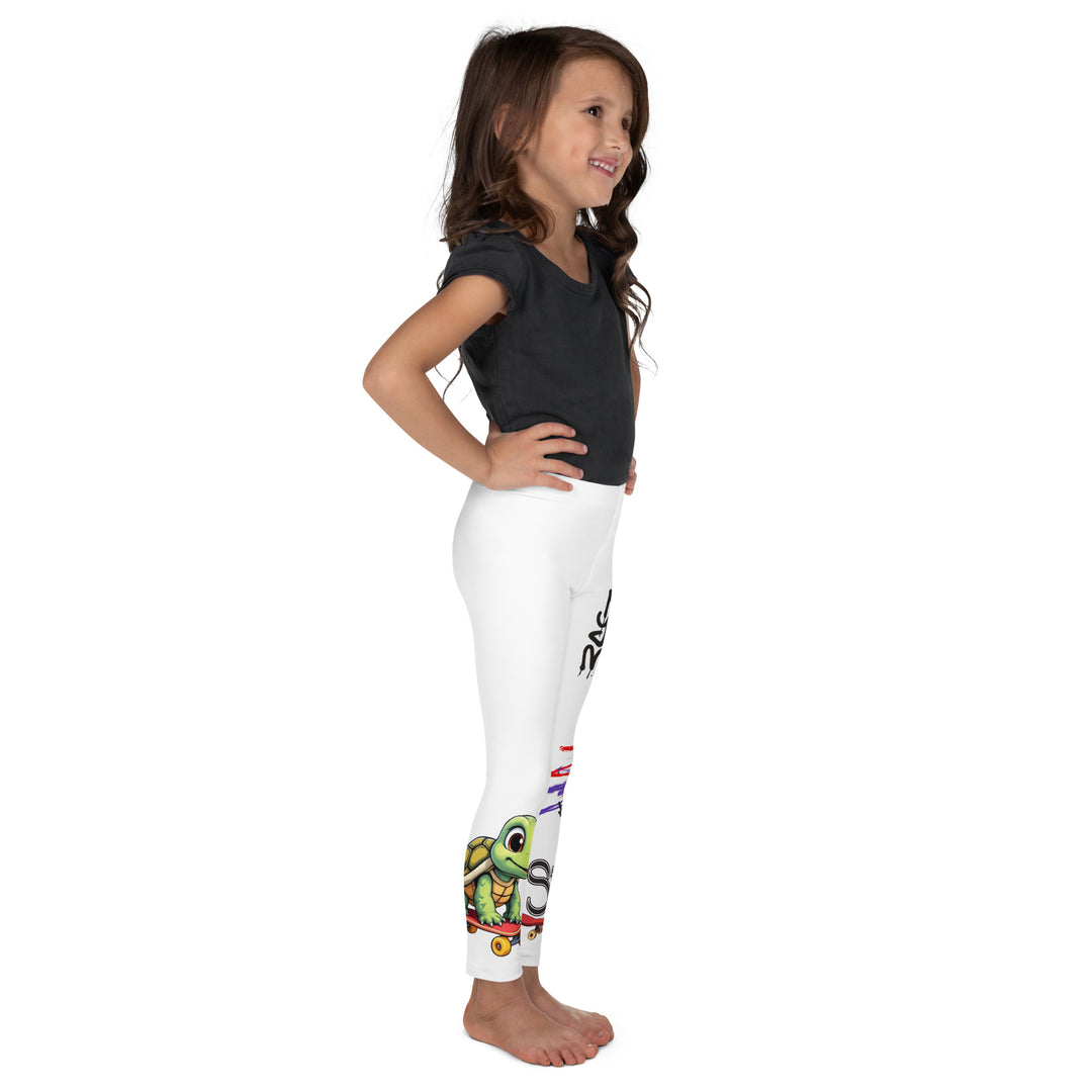  Skater Turtle Girls Leggings, white background with a green turtle riding a skateboard on one leg, black "MAKE YOUR MOVE" text and black skater silhouette with pink and purple motion lines on the other leg, and a skateboard with "skate" text at the bottom of the leg, right side view on model