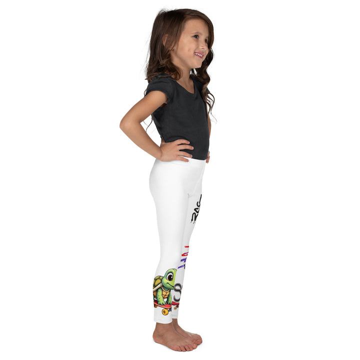  Skater Turtle Girls Leggings, white background with a green turtle riding a skateboard on one leg, black "MAKE YOUR MOVE" text and black skater silhouette with pink and purple motion lines on the other leg, and a skateboard with "skate" text at the bottom of the leg, right side view on model