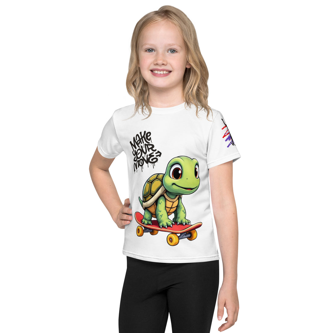 Skater Turtle Girls T-shirt, white background with a green turtle on a skateboard and black "MAKE YOUR MOVE" text on the front, black skater silhouette with pink and purple motion lines on the left sleeve, and a skateboard with "SKATE" text at the bottom back of the shirt, front view on model