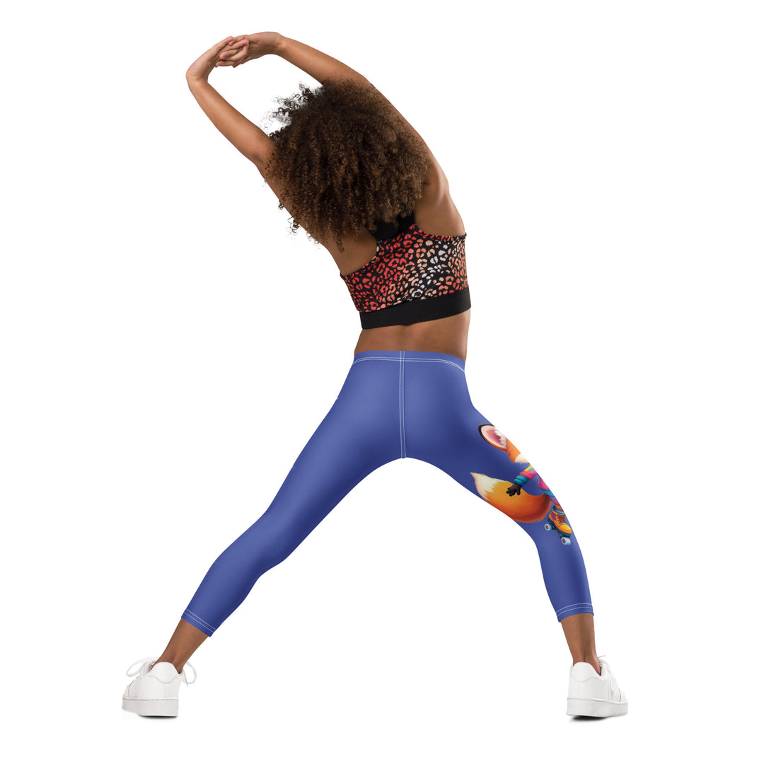 Starlight Fox Girls Leggings, dark blue background with a fox wearing blue, pink, and yellow sporty outfit on roller skates on one leg, and large sparkling white stars with small matching stars running down the other leg, back angle with relaxed pose on model