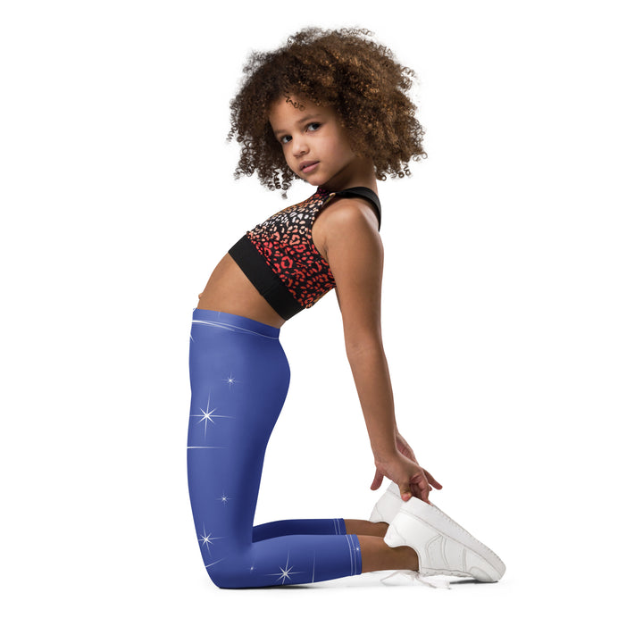 Starlight Fox Girls Leggings, dark blue background with a fox wearing blue, pink, and yellow sporty outfit on roller skates on one leg, and large sparkling white stars with small matching stars running down the other leg, left side view kneeling on model