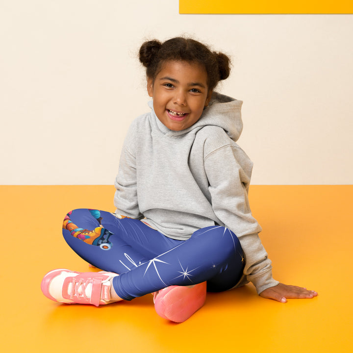 Starlight Fox Girls Leggings, dark blue background with a fox wearing blue, pink, and yellow sporty outfit on roller skates on one leg, and large sparkling white stars with small matching stars running down the other leg, seated pose on model