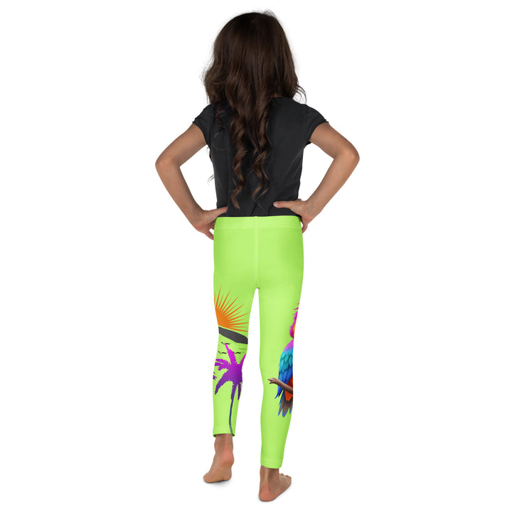  Sunset Parrot Girls Leggings, neon green background with an orange, blue, and purple parrot standing on a branch on one leg, and an orange sunset with flying birds and a purple palm tree on the other leg, back view on model