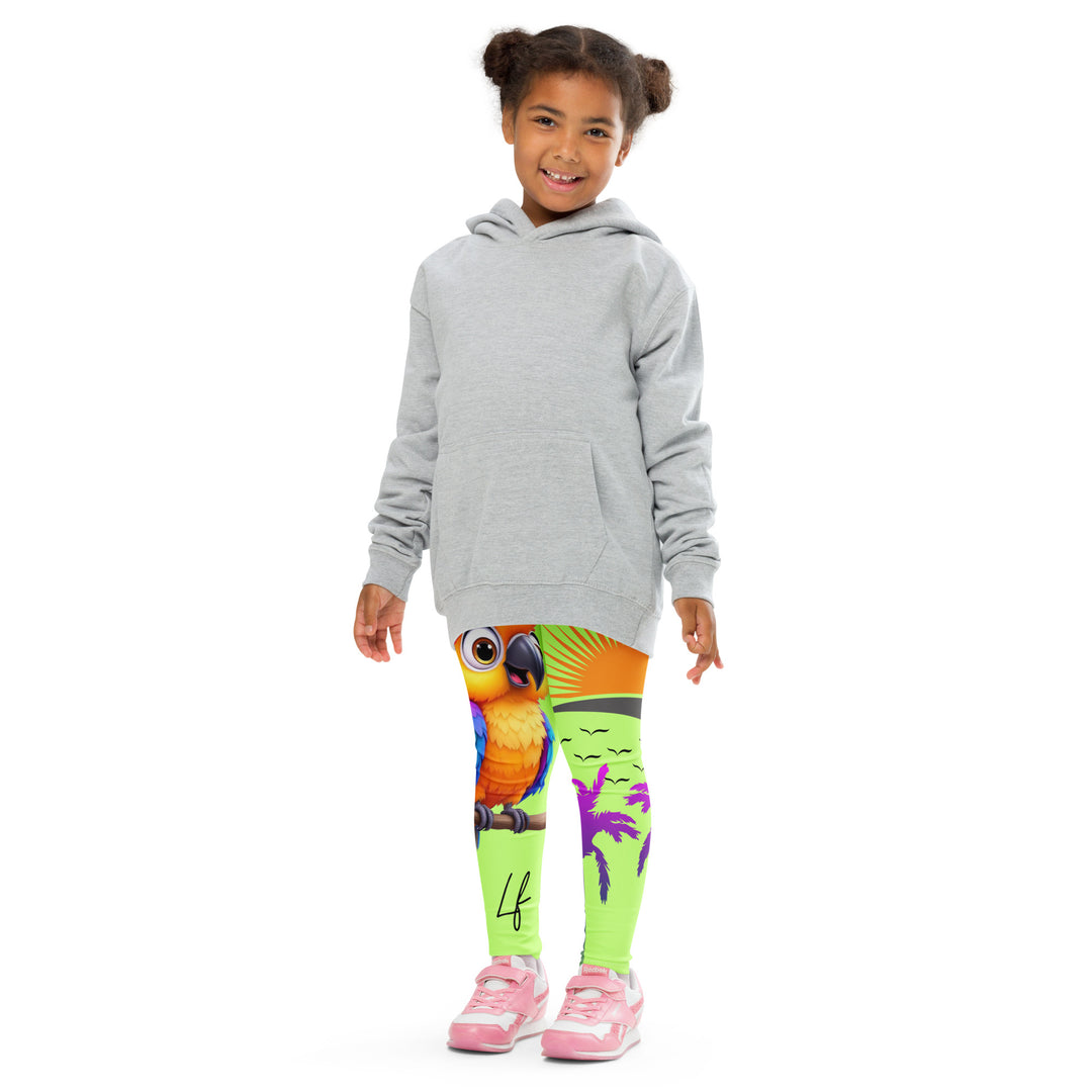 Sunset Parrot Girls Leggings, neon green background with an orange, blue, and purple parrot standing on a branch on one leg, and an orange sunset with flying birds and a purple palm tree on the other leg, front pose with arms at sides on model