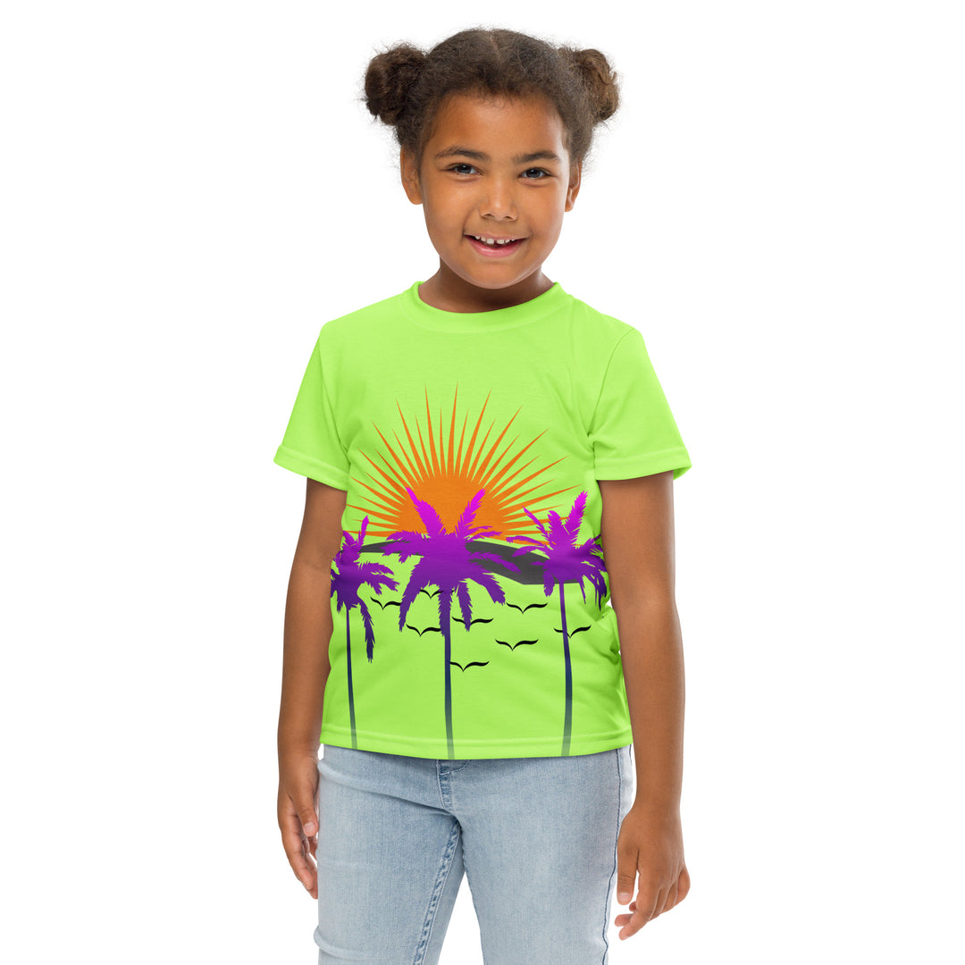 Sunset Parrot Girls T-shirt, neon green background with an orange sunset, flying birds, and three purple palm trees on the front, and an orange, purple, and blue parrot standing on a branch on the back, front pose with arms at sides on model