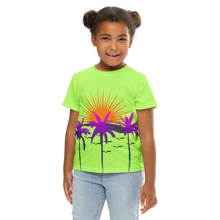 Sunset Parrot Girls T-shirt, neon green background with an orange sunset, flying birds, and three purple palm trees on the front, and an orange, purple, and blue parrot standing on a branch on the back, front pose with arms at sides on model