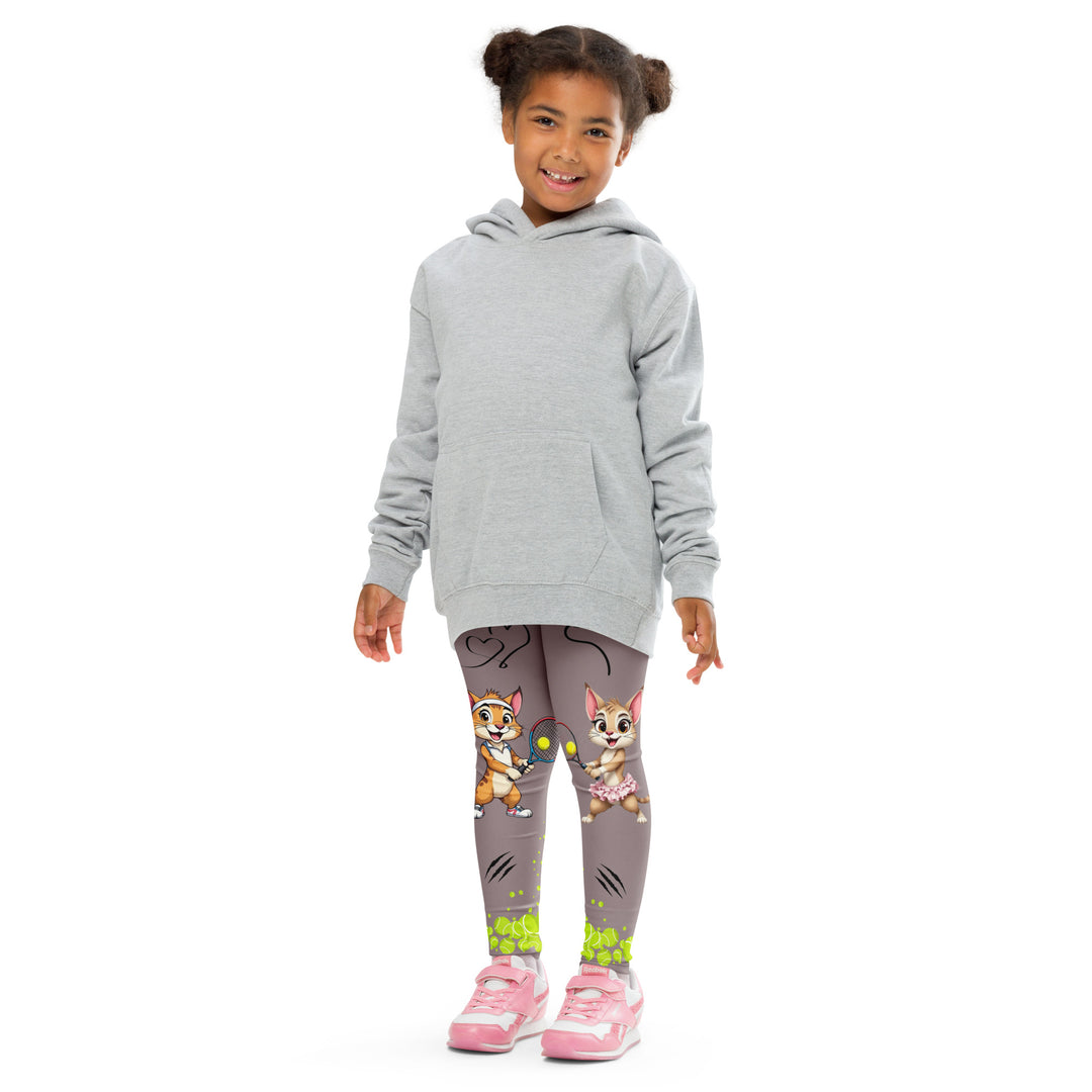 Tennis Kittens Girls Leggings, dark gray background with a cat holding a tennis racket on one leg and a kitten with a tennis racket on the other leg, each racket with a tennis ball as if playing, dressed in sporty outfits, with neon green tennis balls, hearts, and "love" text, front pose with arms at sides on model