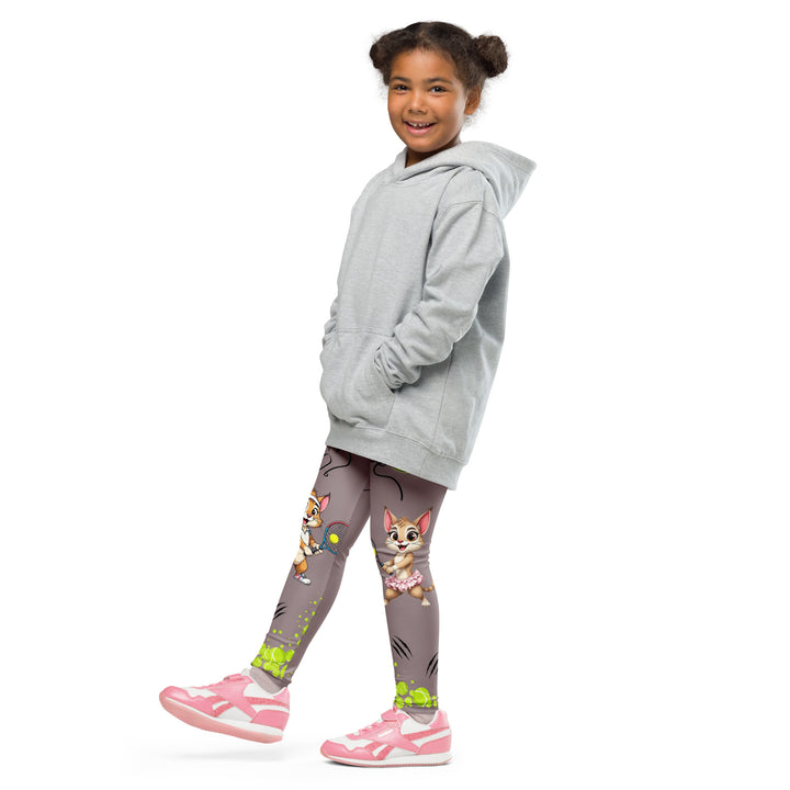 Tennis Kittens Girls Leggings, dark gray background with a cat holding a tennis racket on one leg and a kitten with a tennis racket on the other leg, each racket with a tennis ball as if playing, dressed in sporty outfits, with neon green tennis balls, hearts, and "love" text, front view with one leg lifted and extended on model