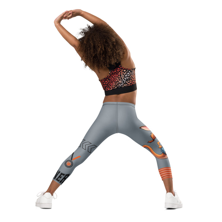  Track Runner Kangaroo Girls Leggings, dark gray background with a sporty kangaroo running on an orange track on one leg, "get ready" text in black and orange above, and an orange and black medal with "runner" text in the lower corner on the other leg, back angle with relaxed pose on model