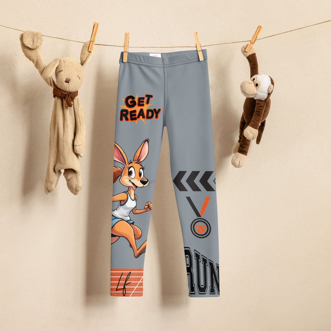  Track Runner Kangaroo Girls Leggings, dark gray background with a sporty kangaroo running on an orange track on one leg, "get ready" text in black and orange above, and an orange and black medal with "runner" text in the lower corner on the other leg, front view on hanger
