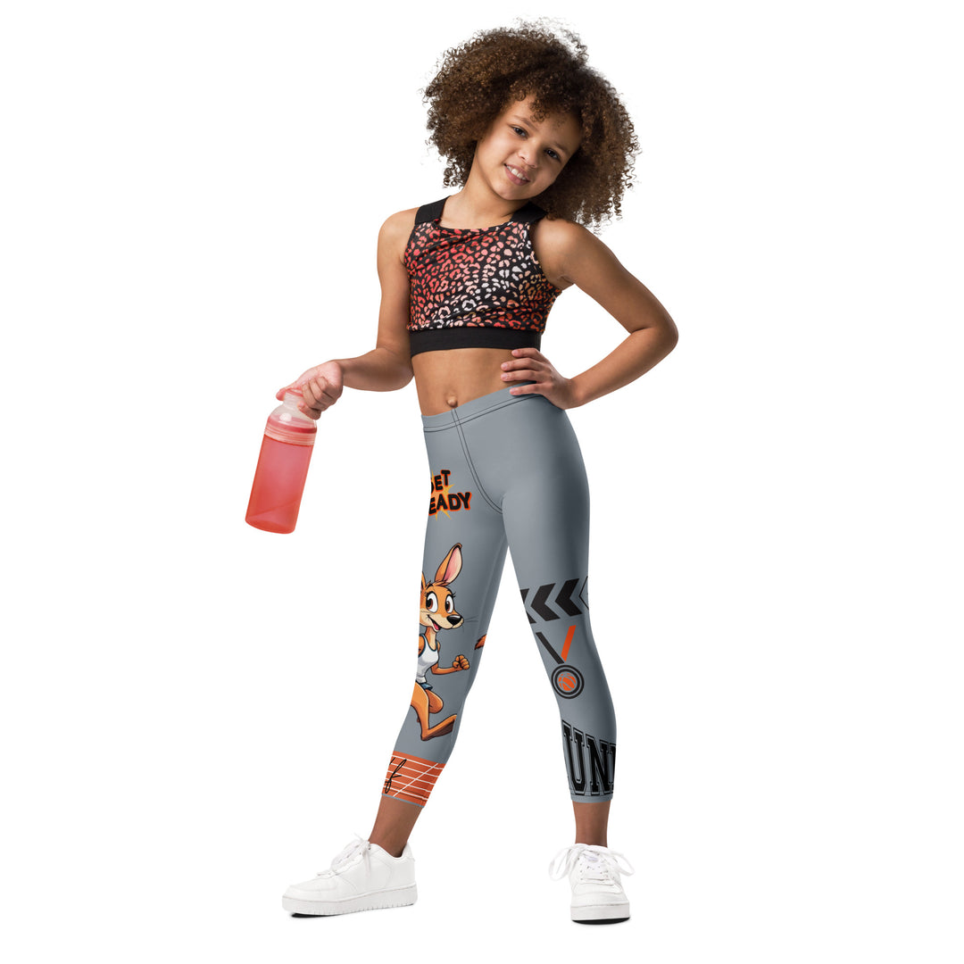 Track Runner Kangaroo Girls Leggings, dark gray background with a sporty kangaroo running on an orange track on one leg, "get ready" text in black and orange above, and an orange and black medal with "runner" text in the lower corner on the other leg, relaxed front pose on model