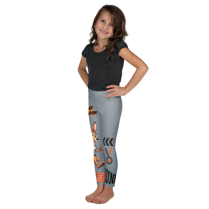 Track Runner Kangaroo Girls Leggings, dark gray background with a sporty kangaroo running on an orange track on one leg, "get ready" text in black and orange above, and an orange and black medal with "runner" text in the lower corner on the other leg, left side view on model
