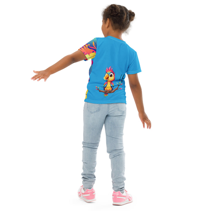  Tropical Leaves & Parrot Girls T-shirt, blue background with colorful tropical leaves in purple, pink, yellow, and orange running down the left side and continuing onto the left sleeve on the front, and a blue, pink, and yellow parrot sitting on a branch on the back, back pose on model