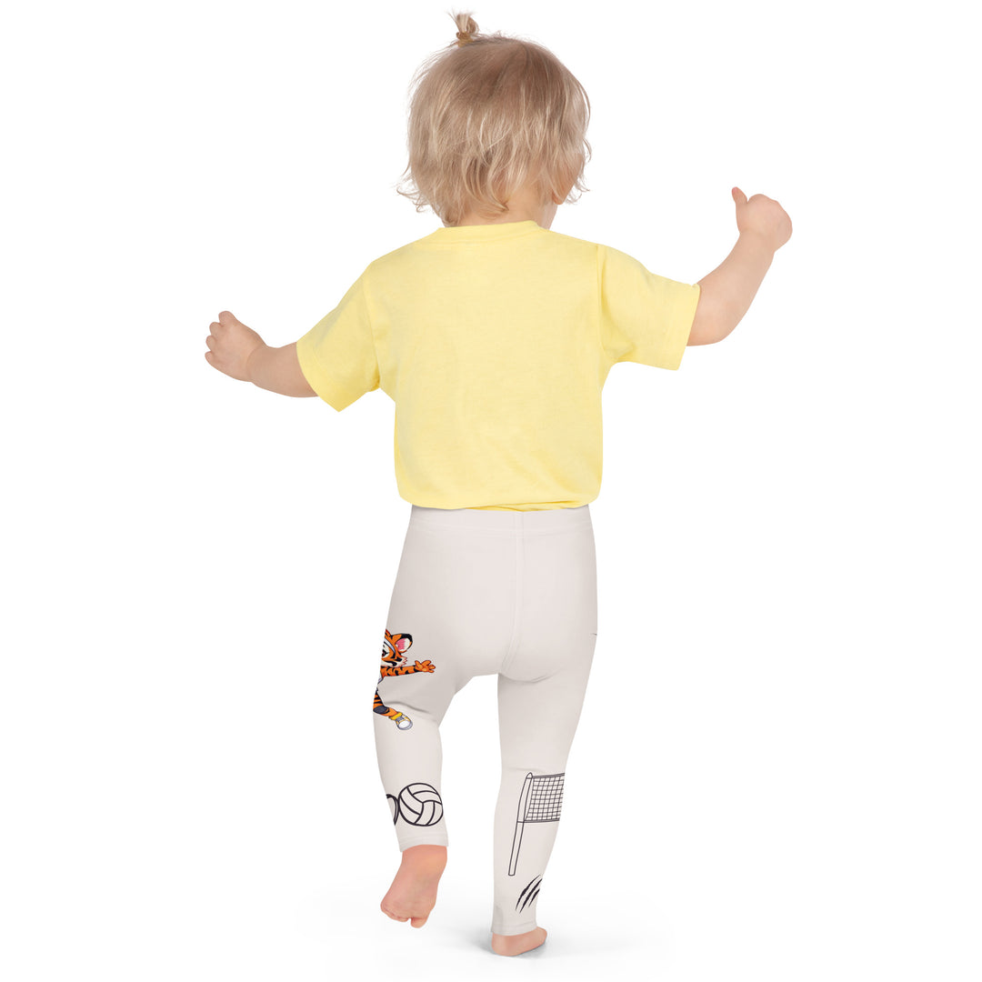 Volley Queen Tiger Girls Leggings, beige background with one leg featuring a sporty dressed tiger holding a volleyball, and the other leg with a volleyball net and a ball leaving a motion trail, back pose on model.