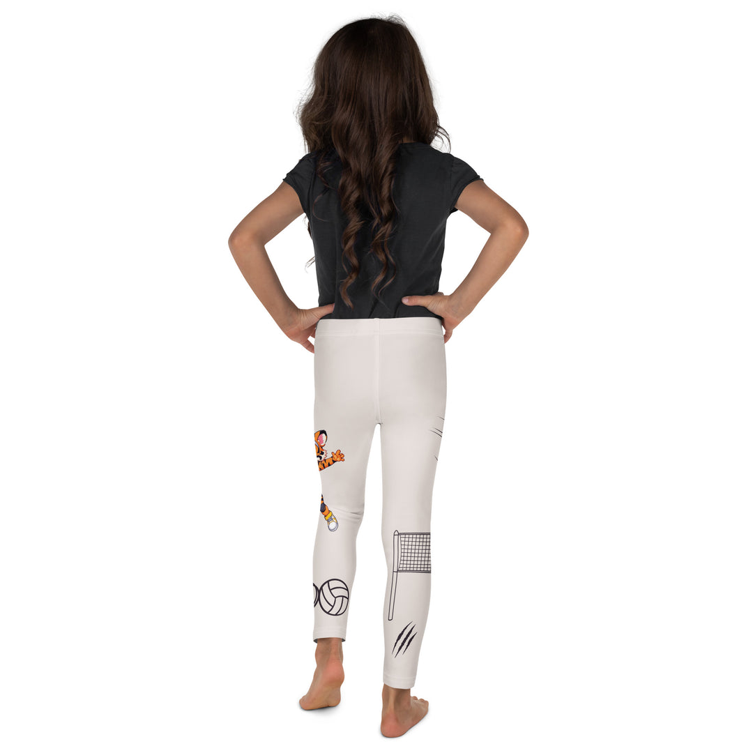  Volley Queen Tiger Girls Leggings, beige background with one leg featuring a sporty dressed tiger holding a volleyball, and the other leg with a volleyball net and a ball leaving a motion trail, back view on model