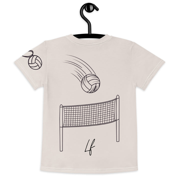 Volley Queen Tiger Girls T-shirt, beige background with a sporty dressed tiger holding a volleyball on the front, a heart, volleyball, and peace sign on the left sleeve, and a volleyball net with a ball leaving a motion trail on the back, back view on hanger