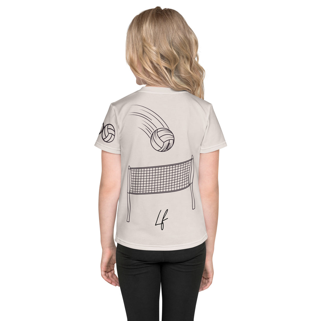 Volley Queen Tiger Girls T-shirt, beige background with a sporty dressed tiger holding a volleyball on the front, a heart, volleyball, and peace sign on the left sleeve, and a volleyball net with a ball leaving a motion trail on the back, back view on model