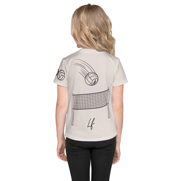 Volley Queen Tiger Girls T-shirt, beige background with a sporty dressed tiger holding a volleyball on the front, a heart, volleyball, and peace sign on the left sleeve, and a volleyball net with a ball leaving a motion trail on the back, back view on model