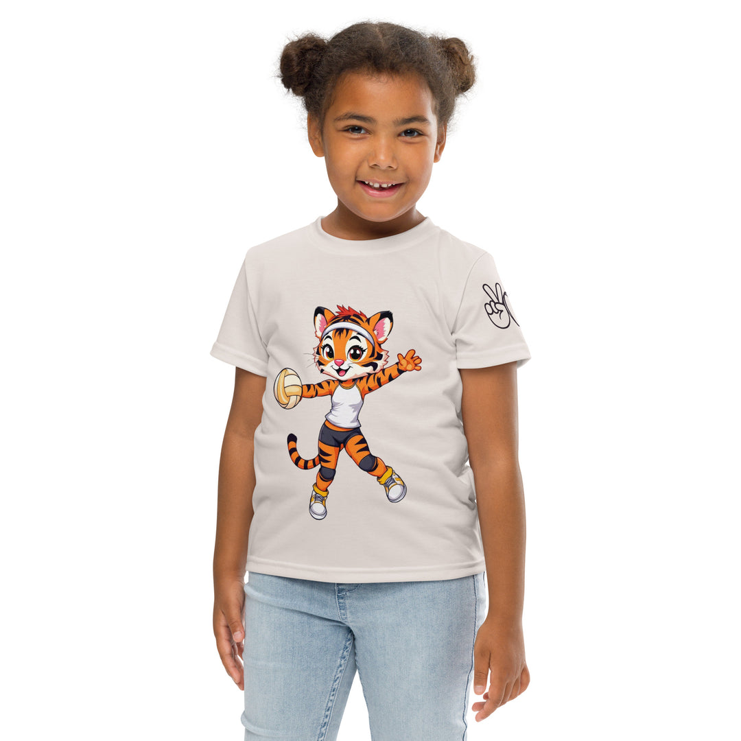Volley Queen Tiger Girls T-shirt, beige background with a sporty dressed tiger holding a volleyball on the front, a heart, volleyball, and peace sign on the left sleeve, and a volleyball net with a ball leaving a motion trail on the back, front pose with arms at sides on model