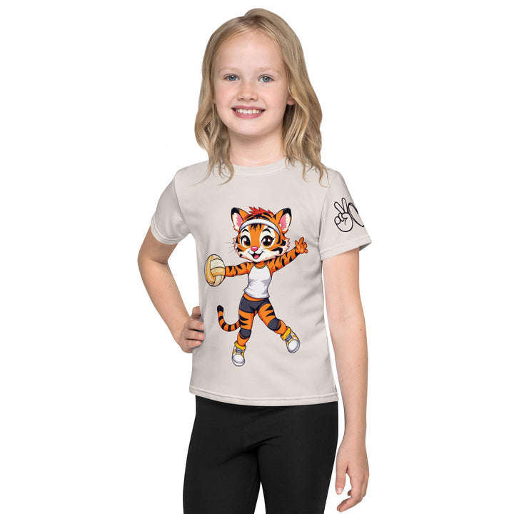  Volley Queen Tiger Girls T-shirt, beige background with a sporty dressed tiger holding a volleyball on the front, a heart, volleyball, and peace sign on the left sleeve, and a volleyball net with a ball leaving a motion trail on the back, front view on model