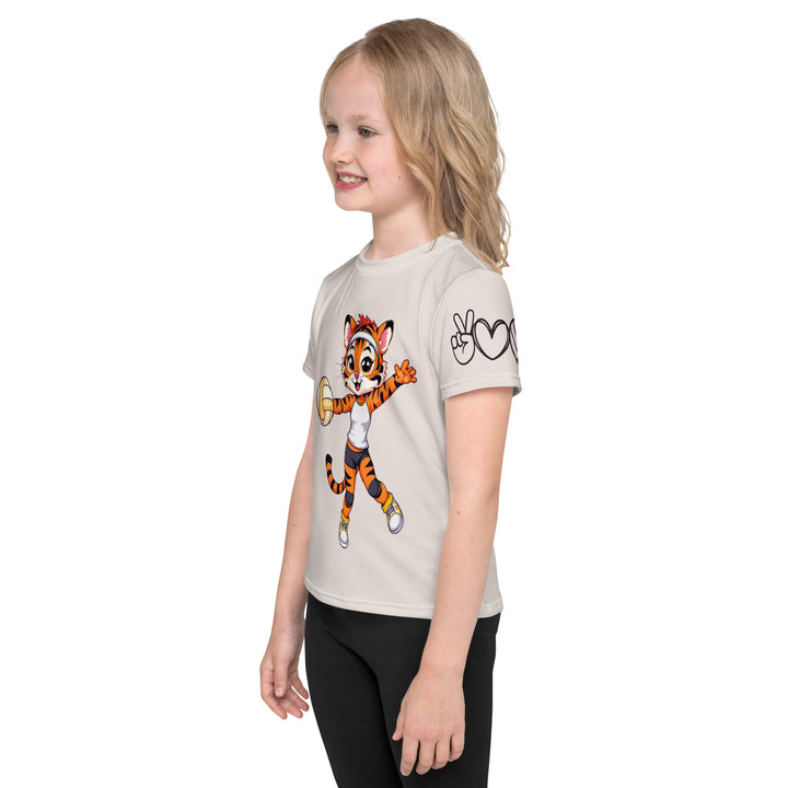  Volley Queen Tiger Girls T-shirt, beige background with a sporty dressed tiger holding a volleyball on the front, a heart, volleyball, and peace sign on the left sleeve, and a volleyball net with a ball leaving a motion trail on the back, left side view on model