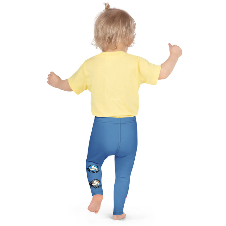 Volleyball Tiger Girls Leggings, blue background with a sporty dressed tiger holding a volleyball on one leg, and colorful glowing volleyballs on the other leg, back pose on model
