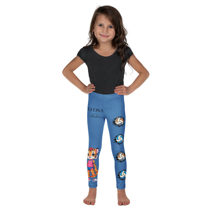 Volleyball Tiger Girls Leggings, blue background with a sporty dressed tiger holding a volleyball on one leg, and colorful glowing volleyballs on the other leg, relaxed front pose on model-with a visible 'Leona Fashion' text on the design
