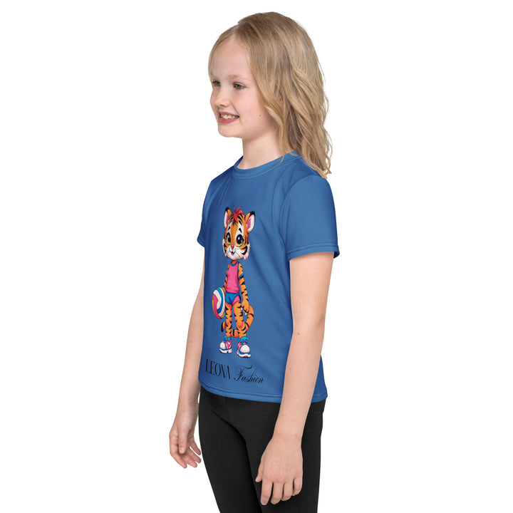  Volleyball Tiger Girls T-shirt, blue background with a sporty dressed tiger holding a volleyball on the front, and colorful glowing volleyballs on the back, left side view on model-with a visible 'Leona Fashion' text on the design