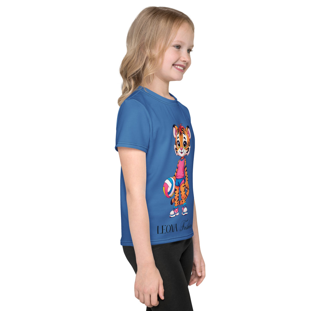  Volleyball Tiger Girls T-shirt, blue background with a sporty dressed tiger holding a volleyball on the front, and colorful glowing volleyballs on the back, right side view on model-with a visible 'Leona Fashion' text on the design