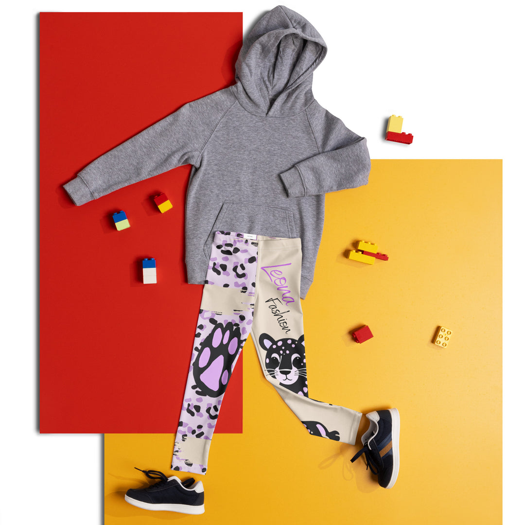 Wild Kitty Paw Purple Girls Leggings, cream background with a black panther featuring soft lavender spots on one leg, and a black and lavender tiger-striped pattern with a large matching paw on the other leg, mixed with cream details, front view laid flat on floor-with a visible 'Leona Fashion' text on the design