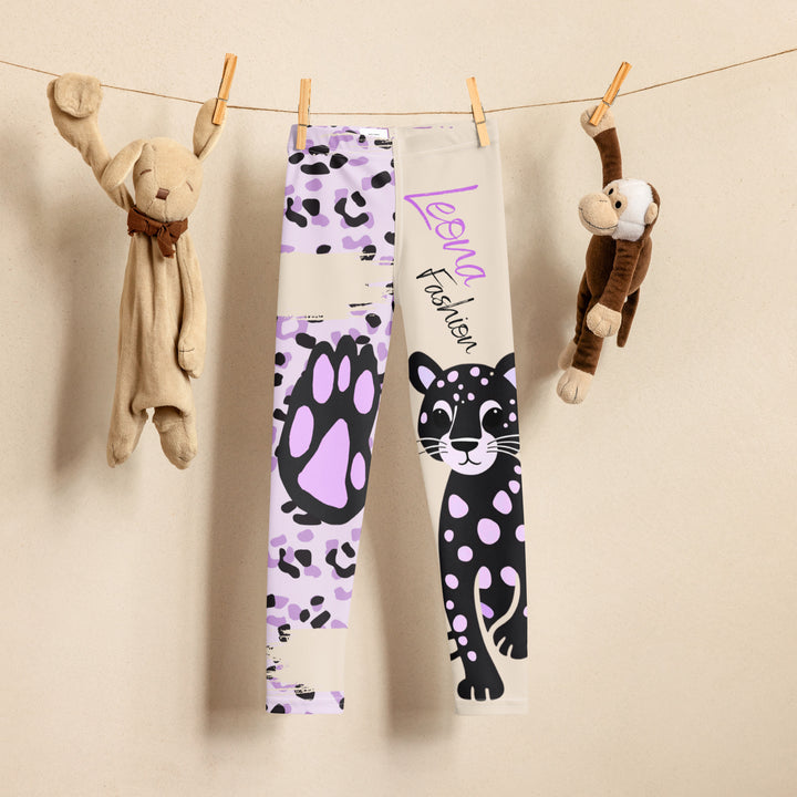 Wild Kitty Paw Purple Girls Leggings, cream background with a black panther featuring soft lavender spots on one leg, and a black and lavender tiger-striped pattern with a large matching paw on the other leg, mixed with cream details, front view on hanger-with a visible 'Leona Fashion' text on the design