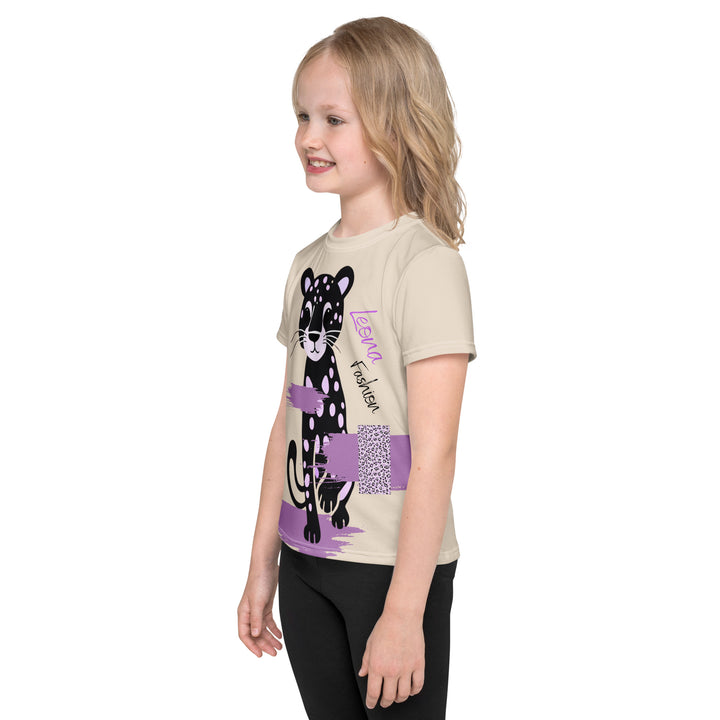 Wild Kitty Paw Purple Girls T-shirt, cream background with a black panther featuring soft lavender spots, accented by lavender brushstroke shapes and a cream tiger-print rectangular pattern, left side view on model-with a visible 'Leona Fashion' text on the design