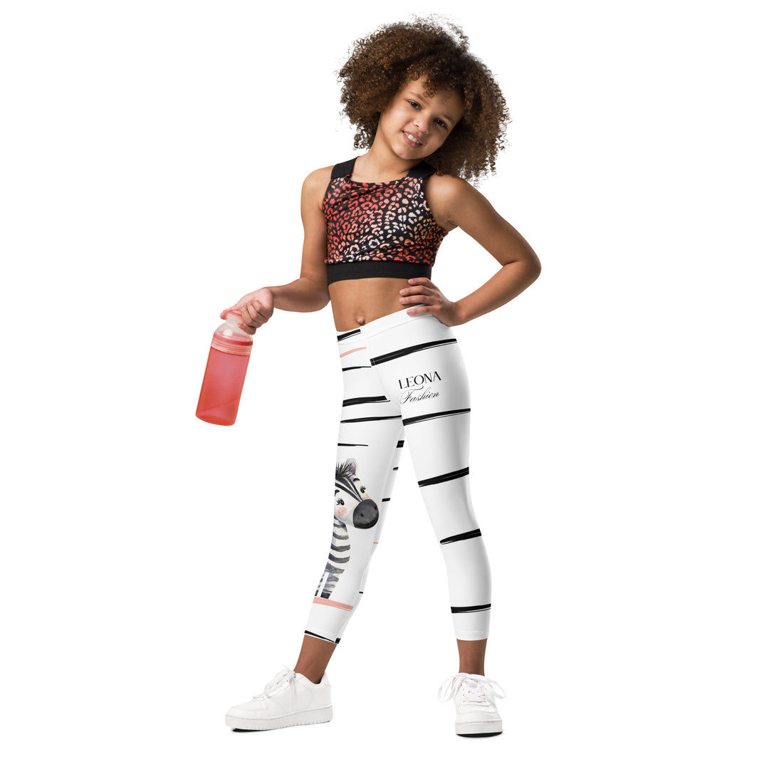 Zebra Blush Glow Girls Leggings, white with black and white zebra print and blush pink stripes - front fit on model-with a visible 'Leona Fashion' text on the design