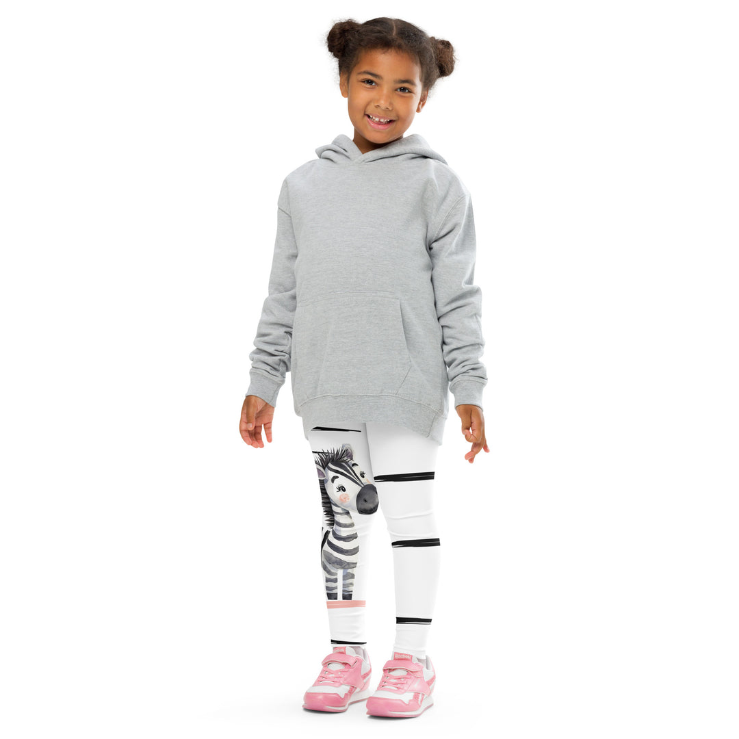 Zebra Blush Glow Girls Leggings, white with black and white zebra print and blush pink stripes - model view from the front-with a visible 'Leona Fashion' text on the design