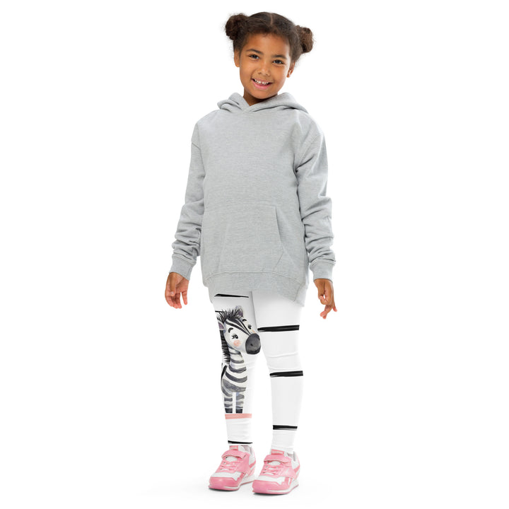 Zebra Blush Glow Girls Leggings, white with black and white zebra print and blush pink stripes - model view from the front-with a visible 'Leona Fashion' text on the design