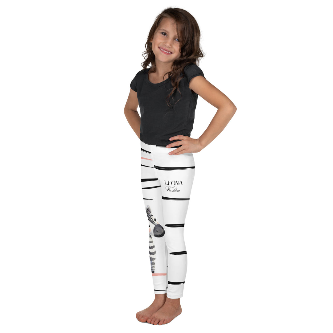 Zebra Blush Glow Girls Leggings, white with black and white zebra print and blush pink stripes – side angle showing fit-with a visible 'Leona Fashion' text on the design