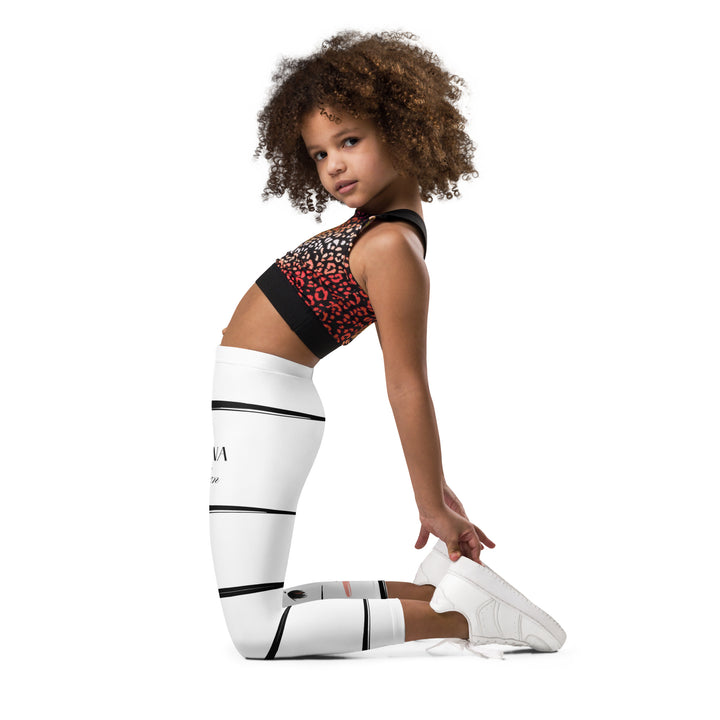 Zebra Blush Glow Girls Leggings, white with black and white zebra print and blush pink stripes – side fit on model-with a visible 'Leona Fashion' text on the design