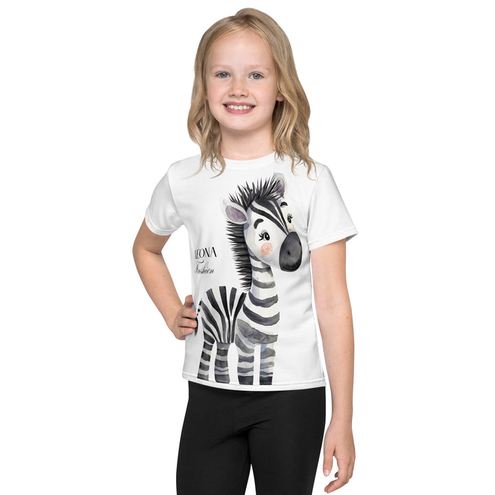 Zebra Blush Glow Girls T-shirt, white with black and white zebra print, front angle shown on model-with a visible 'Leona Fashion' text on the design