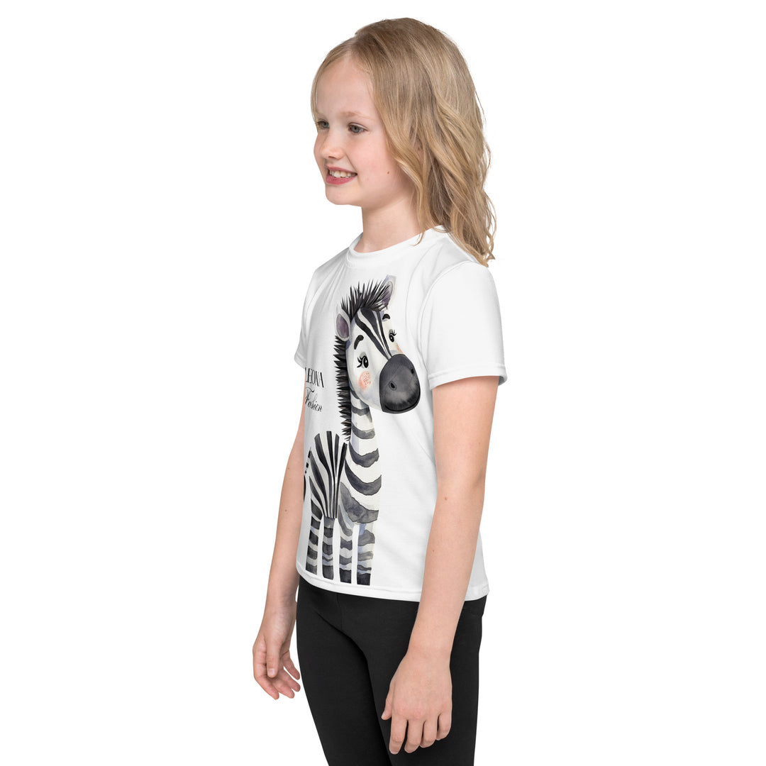 Zebra Blush Glow Girls T-shirt, white with black and white zebra print, side view shown on model-with a visible 'Leona Fashion' text on the design