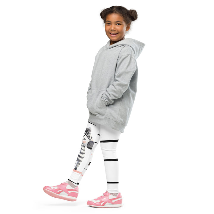 Zebra Blush Glow Girls Leggings, white with black and white zebra print and blush pink stripes – side view on model with one leg raised
